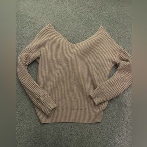 Pink knit sweater. Back of sweater is tied. Brand is Love tree. Small